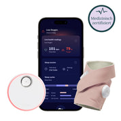 Bild einer Owletcare.de Owlet Dream Sock: Medizinisch zertifiziertes Pulsoximeter für Babys mit Echtzeitüberwachung der Vitalwerte. Das Produkt enthält eine Smartphone-App, die Sauerstoffwerte, Pulsfrequenz und Schlafdaten anzeigt. Abgebildet sind eine runde Basisstation und ein Babysockensensor aus rosa Stoff. Auf einem Abzeichen steht „Medizinisch zertifiziert“.